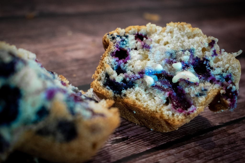 Blueberry Muffin cut in half with butter melting